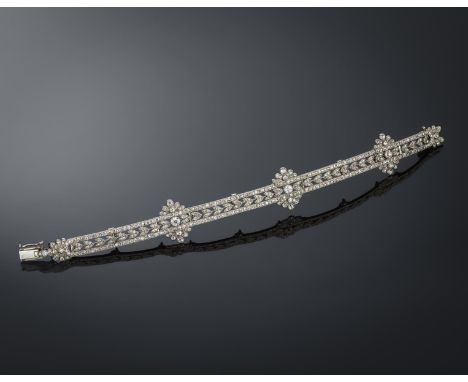A Belle Époque diamond bracelet by Boucheron, the hinged panels centred with laurel leaves within straight line borders and w