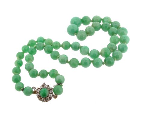 A single-row jade bead necklace, the graduated green jade beads measure 7 - 11mm and are set with a jade bead and diamond clu
