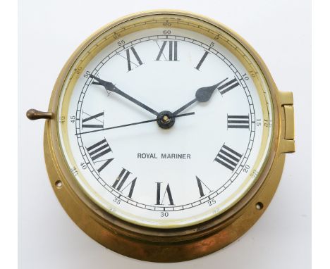 A brass cased 19cm bulkhead clock, with an enamel dial featuring Arabic and Roman numerals and stamped 'Royal Mariner', with 