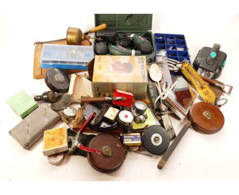 A collection of mid twentieth century tools to include tape measures, garden hand tools, brass spring balance scales, brass m