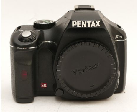 A Pentax K-M DSLR camera, body only, in original box.