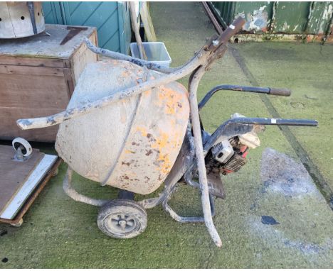 A petrol driven cement mixer, Honda 2.5 G100 engine, recently used and now the job has been finished.