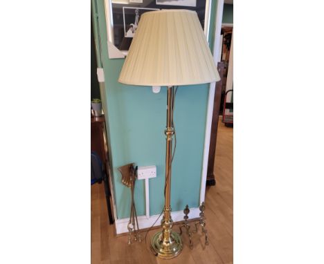 A modern brass standard lamp, having fabric shade, together with brass fire dogs and fire irons.