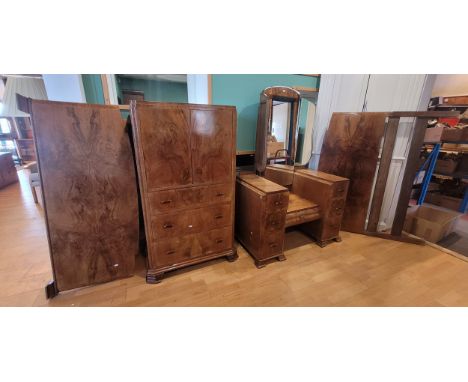 A 1930s Art Deco walnut veneered three piece bedroom suite, comprising a mirrorback dressing table, W106, D58, H160cm, a 'Tal