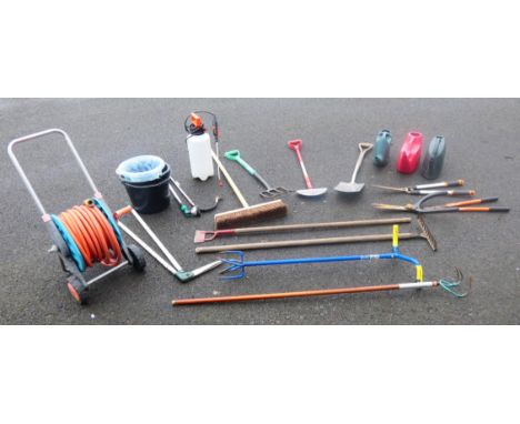 A collection of garden tools to include rakes, folk, spade, hoe, edging spade, weed rakes, sheers, sweeping brush, buckets, p