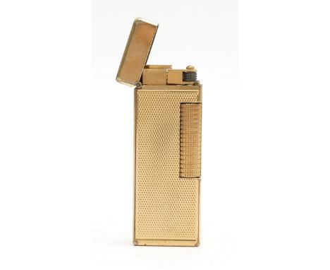 Alfred Dunhill London; A gold plated Rollagas pocket cigarette lighter, having engine turned casing, with fabric pouch.