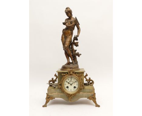 A nineteenth century French marble mantel clock, surmounted by a bronzed spelter figure depicting the Muse of Music, likely E