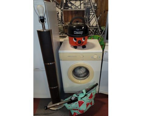 A White Knight tumble dryer together with Henry vacuum cleaner and attatchments and a standing floor lamp. (4 items)