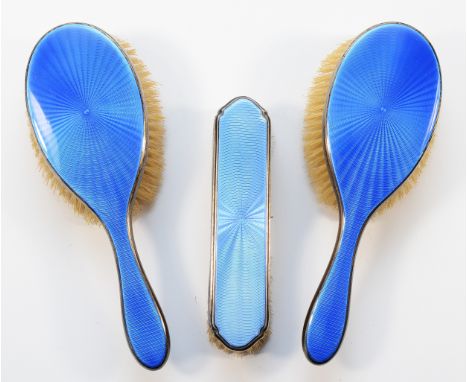 Two silver and blue guilloche enamel dressing table hair brushes, London 1927, together with a silver and light blue guilloch