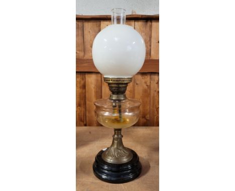An Edwardian oil lamp, clear etched glass reservoir, shaped pearlised shade with glass chimney, on black onyx stepped base, 5