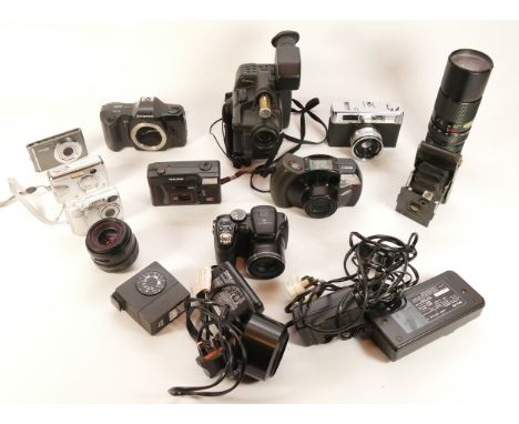 A collection of cameras and camera accessories, to include, a Canon A11 camcorder, a Polaroid iS626, and a Vivitar f/4.5 90-2