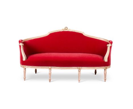 A SWEDISH CARVED, CREAM PAINTED AND UPHOLSTERED SOFA  IN LOUIS XVI STYLE, LATE 19TH CENTURY Upholstered in raspberry mohair v