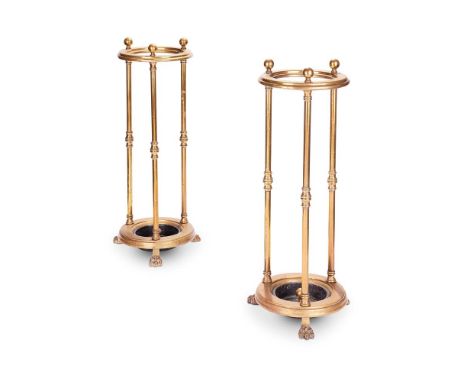 A PAIR OF VICTORIAN CIRCULAR BRASS STICK STANDS  LATE 19TH CENTURY  With ball finials and paw feet, stamped 'W. T&S' for Will