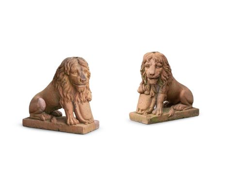 A PAIR OF TERRACOTTA SEATED LIONS  POSSIBLY FRENCH, 19TH CENTURY  Depicted opposing, with paws resting upon carved armorial p