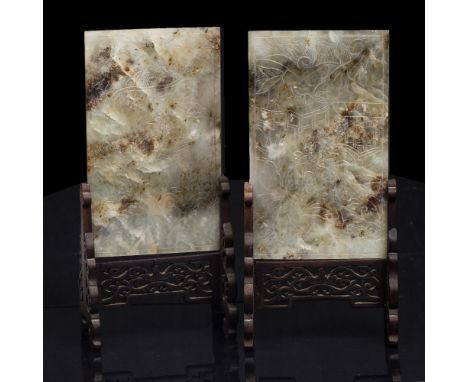 A pair of Chinese rectangular jade panels late 19th Century mounted as screens on carved and pierced wood stands