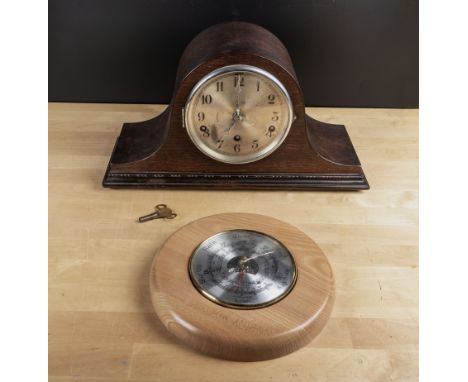 A mantel clock and a small barometer