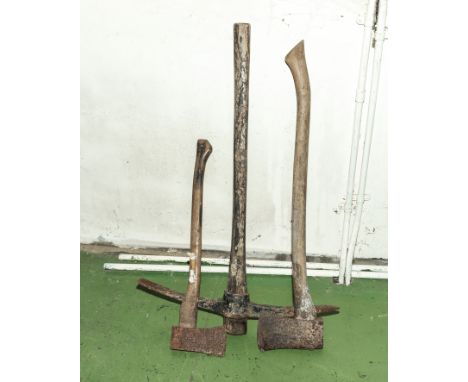 A pick axe and two long handled axes