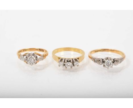 Three diamond rings to include a three stone ring and two single stone rings, all in platinum settings on 18ct gold shanks