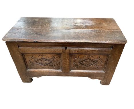 17th century oak two panel coffer, with twin lozenge carved panels to front, carved and dated to frieze 1664, raised on stile