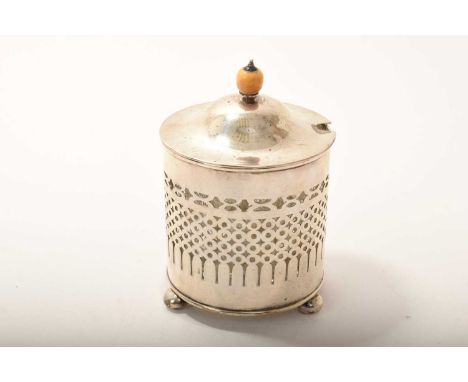 Edwardian silver preserve jar, the cover with ivory knop, removable glass jar and pierced body, on three bun feet, (Birmingha