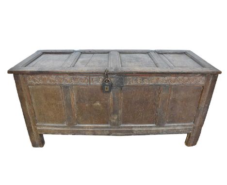 Large 17th century carved oak coffer, with four panel top and carved frieze, initialled EP and dated 1680, raised on stiles, 