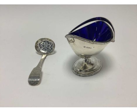 George V silver sugar basket with swing handle, helmet shape bow on splayed pedestal foot and blue glass liner, (Chester 1911