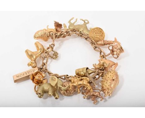 9ct gold charm bracelet with a collection of 9ct gold and yellow metal charms, and three loose charmsTotal weight 69.5 grams