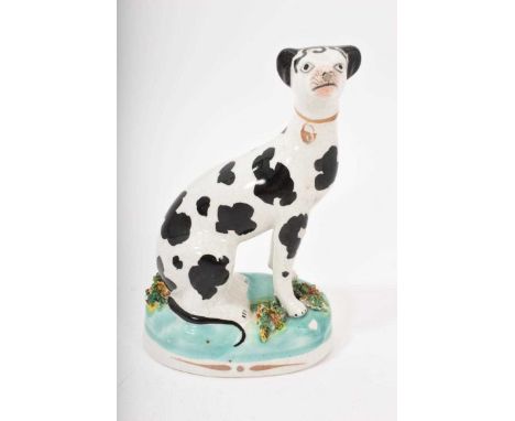 Staffordshire pottery model of a seated Dalmatian, circa 1860, shown seated on an oval base with gilt highlights, 12cm high