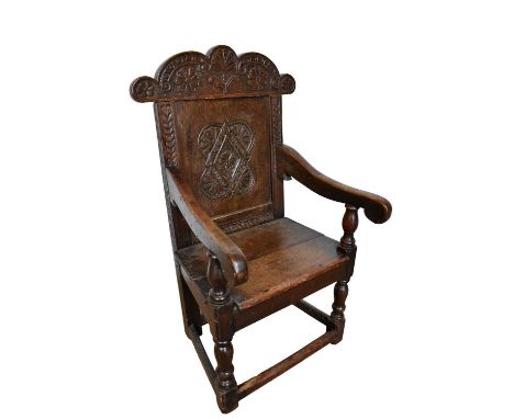 Child's wainscot chair, 17th century, with carved top rail and panelled back, solid seat on turned and block legs