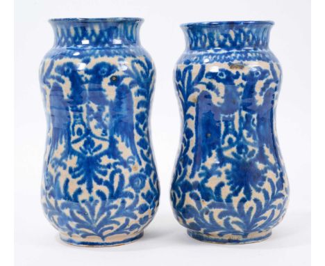 Pair of Spanish blue and white maiolica armorial albarelli, probably 19th century, 19.75 and 20.25cm high