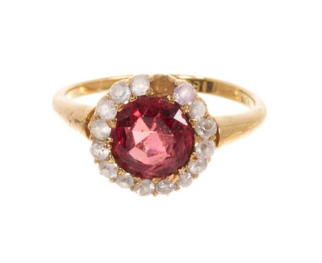 Antique spinel and white sapphire cluster ring with a round mixed cut red spinel measuring 7.5mm diameter, surrounded by a bo