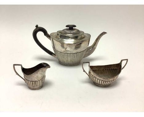 Victorian silver three piece teaset, comprising teapot with half reeded body, hinged domed cover and ebony handle, matching s