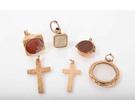 Three gold and yellow metal fob seals, Victorian glazed locket and two 9ct gold cross pendants