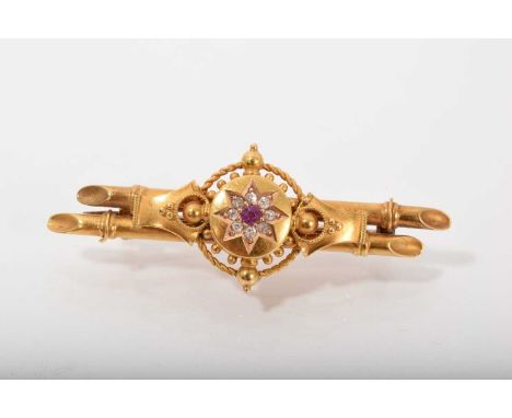 Edwardian 15ct gold brooch with a central ruby and diamond cluster with filigree decoration, Chester 1906. Length 48mm.Excell