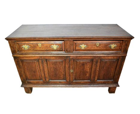 Early 18th century oak dresser base, with fielded panels, enclosed below by pair of doors on stiles, 132cm wide x 38cm deep x