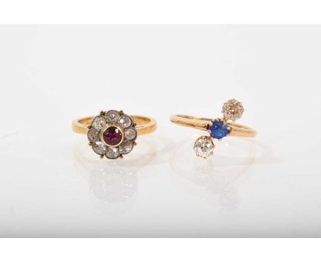 Diamond and ruby flower head cluster ring with a round mixed cut ruby surrounded by eight old cut diamonds in gold setting, r