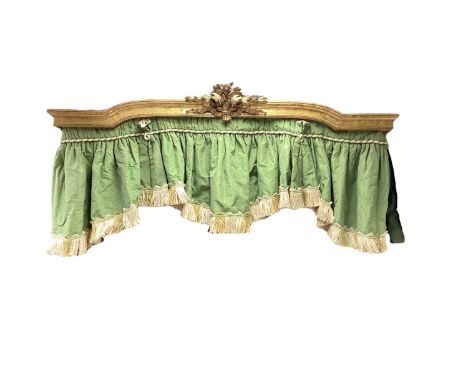 Antique giltwood pelmet with arched central section surmounted with a carved floral bouquet, a green silk panel attached, 58c