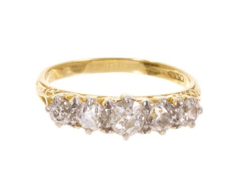 Late Victorian diamond five stone ring with five graduated old cut diamonds in a carved gold scroll setting on tapered 18ct g