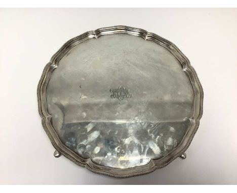 1920s silver salver of circular form, with engraved initials and bead border, on four pad feet (London 1928) Mappin &amp; Web