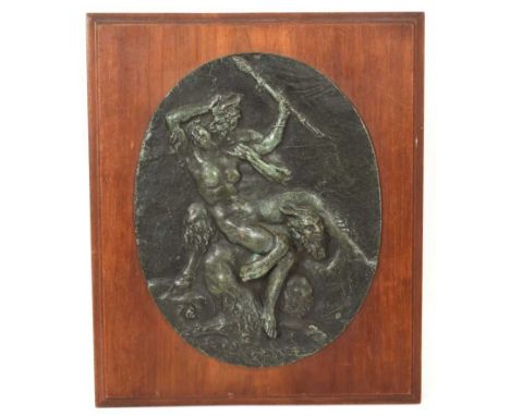 Late 19th century French oval bronze plaque, after Clodion, of a nymph and two satyrs, signed, mounted on wooden plaque total