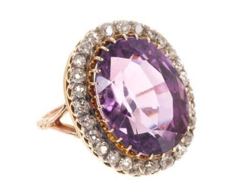 Late Victorian amethyst and diamond cluster ring with a large oval mixed cut amethyst measuring 20.1mm x 15.1mm x 12.1mm, sur