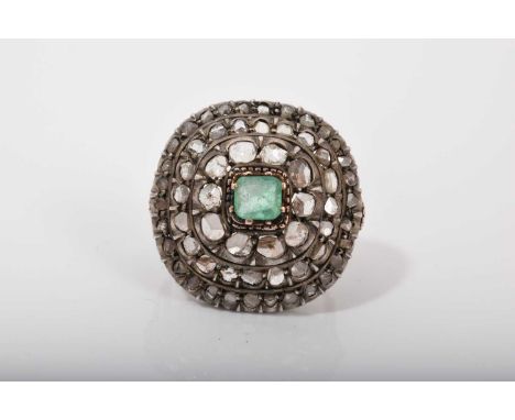 Antique emerald and diamond cluster ring with a central step cut emerald surrounded by three concentric borders of rose cut d