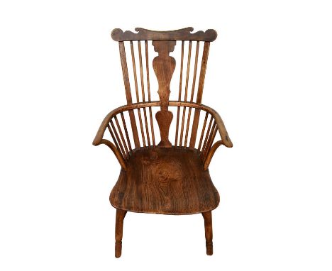 Rare 18th century ash and alm comb back Windsor chair, with shaped top rail and solid vase shaped splat, saddle seat on splay