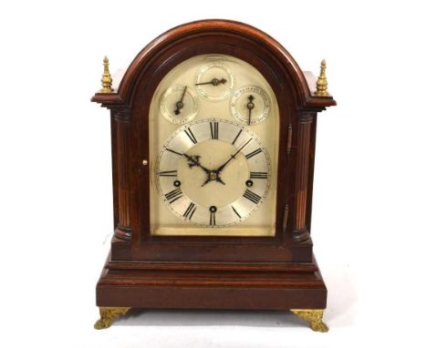 Early 20th century mahogany cased bracket clock chiming on four and eight gongs, silvered arched dial with three subsidiary d