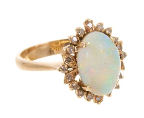 Opal and diamond cluster ring with an oval cabochon opal measuring approximatley 11.6mm x 8mm, surrounded by a border of sing