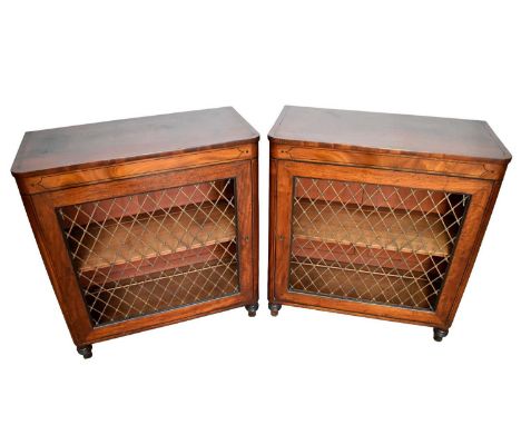 Pair of Regency mahogany pier cabinets, each with rounded angles and ebony line inlay, enclosed by a single grille door on tu