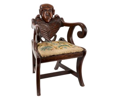 Unusual 1830s Scottish child's chair, the carved splat back with human features, slip in seat on sabre legs