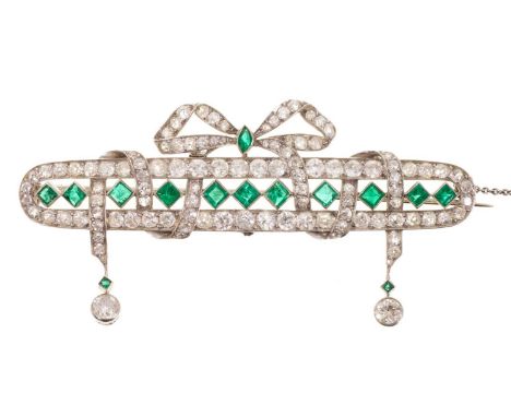 Fine Edwardian Belle Epoqué emerald and diamond plaque brooch, the elongated oval plaque with a line of calibre cut emeralds 