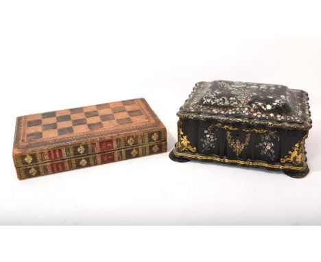 Antique leather games box in the form of two books, folding to reveal tooled leather backgammon board, housing a 19th century