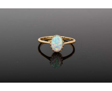 Edwardian opal single stone ring with an oval opal cabochon in claw setting on 18ct gold shank. Ring size PGood condition com